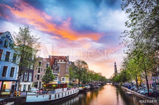 Bild på The most famous canals and embankments of Amsterdam city during sunset General view of the cityscape and traditional Netherlands architecture